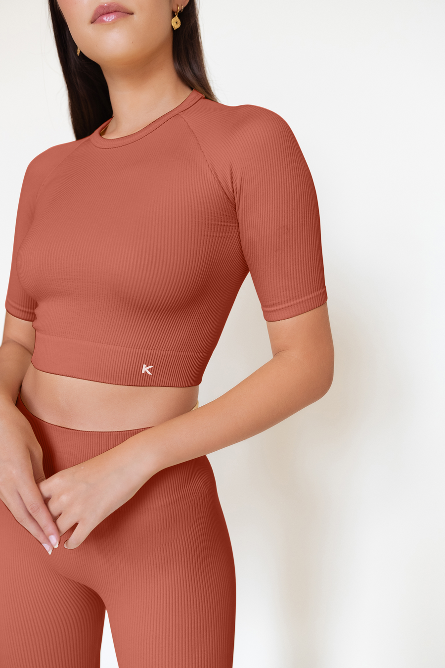 This short sleeve orange crop top is seamless, ribbed and sustainable. 